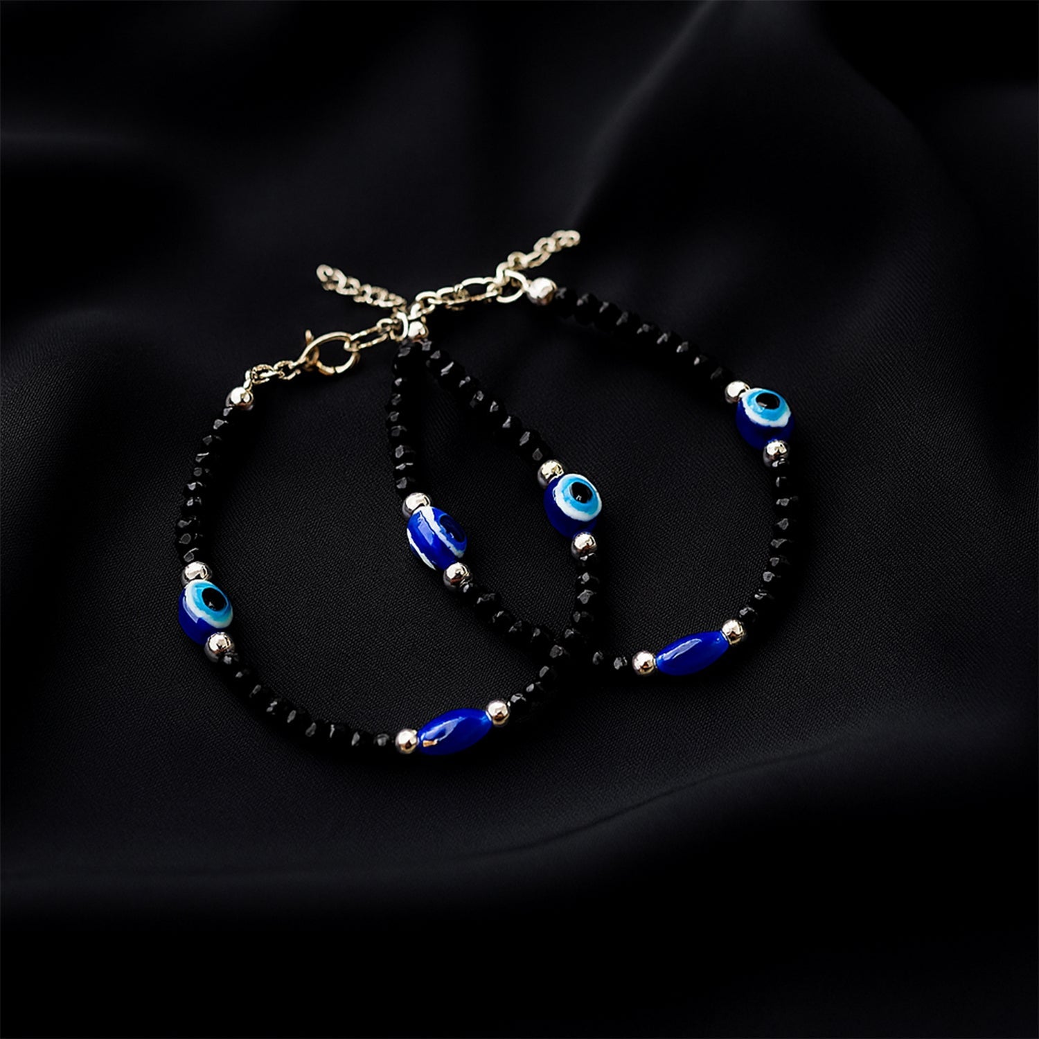 Adjustable black bead evil eye bracelet set with protective charms