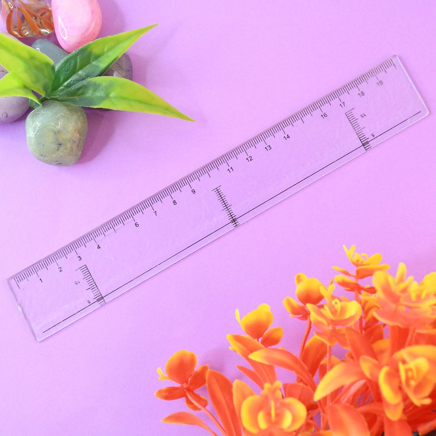 Crystal clear 20 cm plastic ruler placed on white background