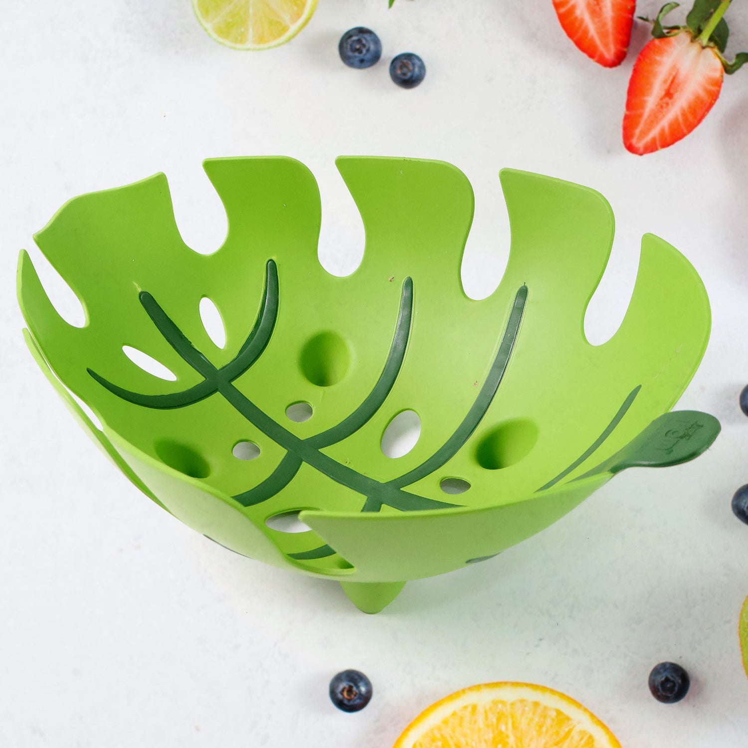Plastic fruit basket showcasing leaf-shaped ventilated pattern