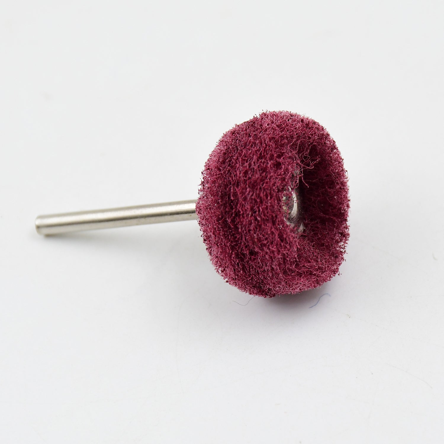 A single maroon buffing wheel with a silver shaft on a white background.