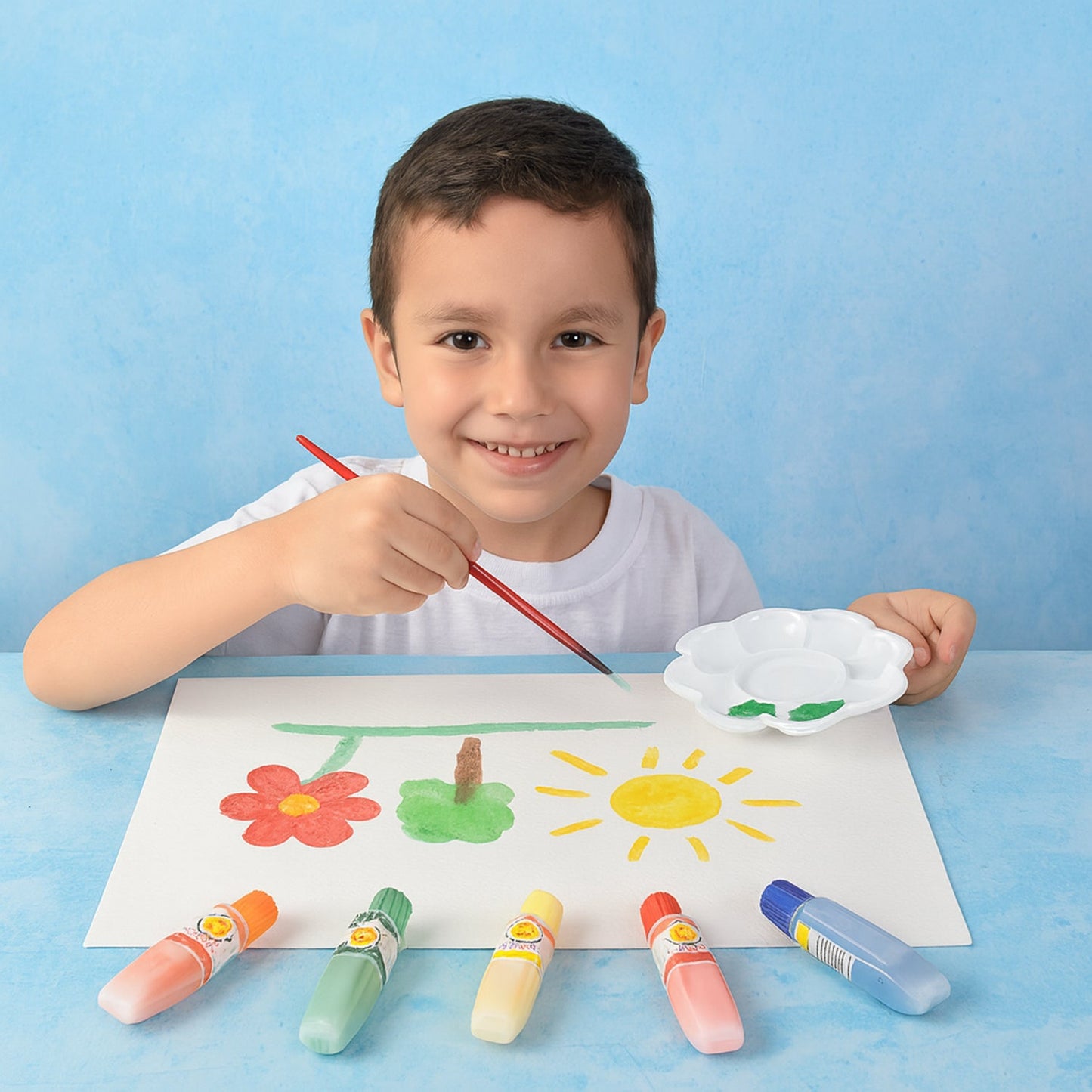 Watercolor paint set with assorted colors arranged with mixing palette and brushes