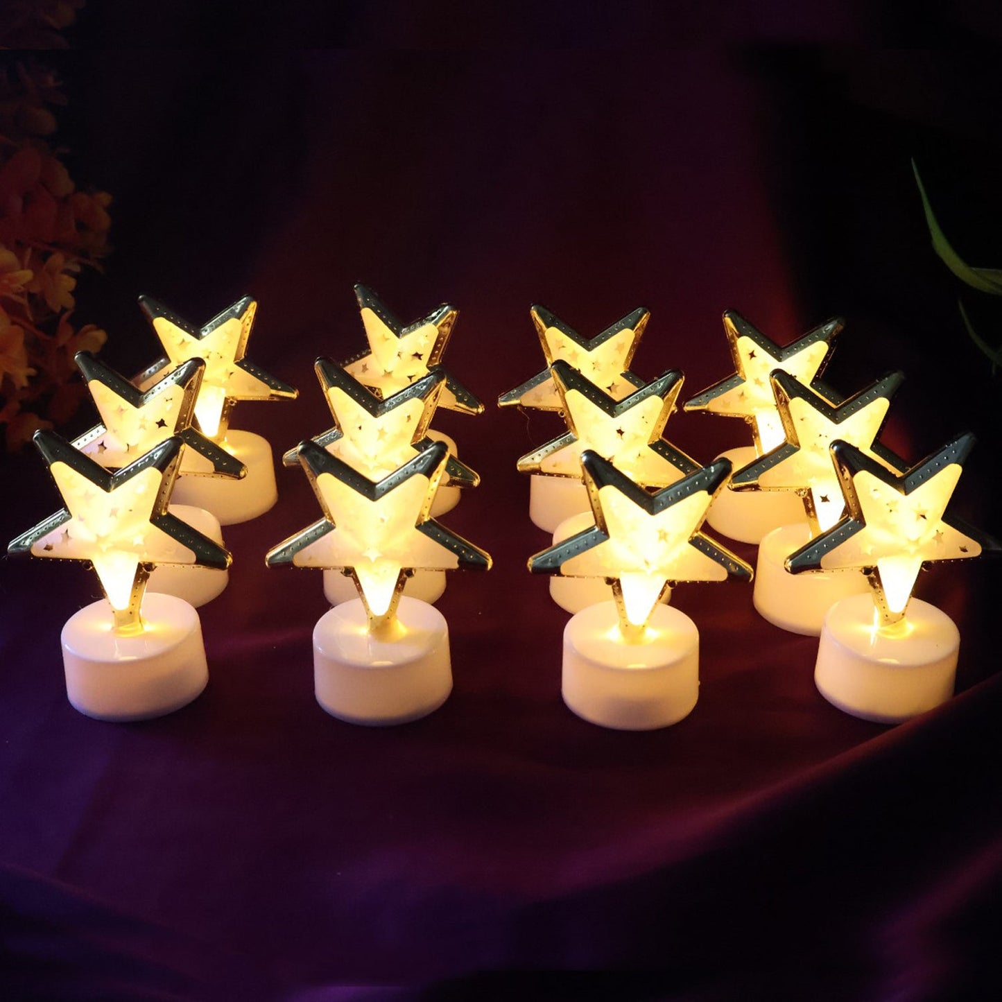 Golden outlined star shaped LED candle providing warm light without flame