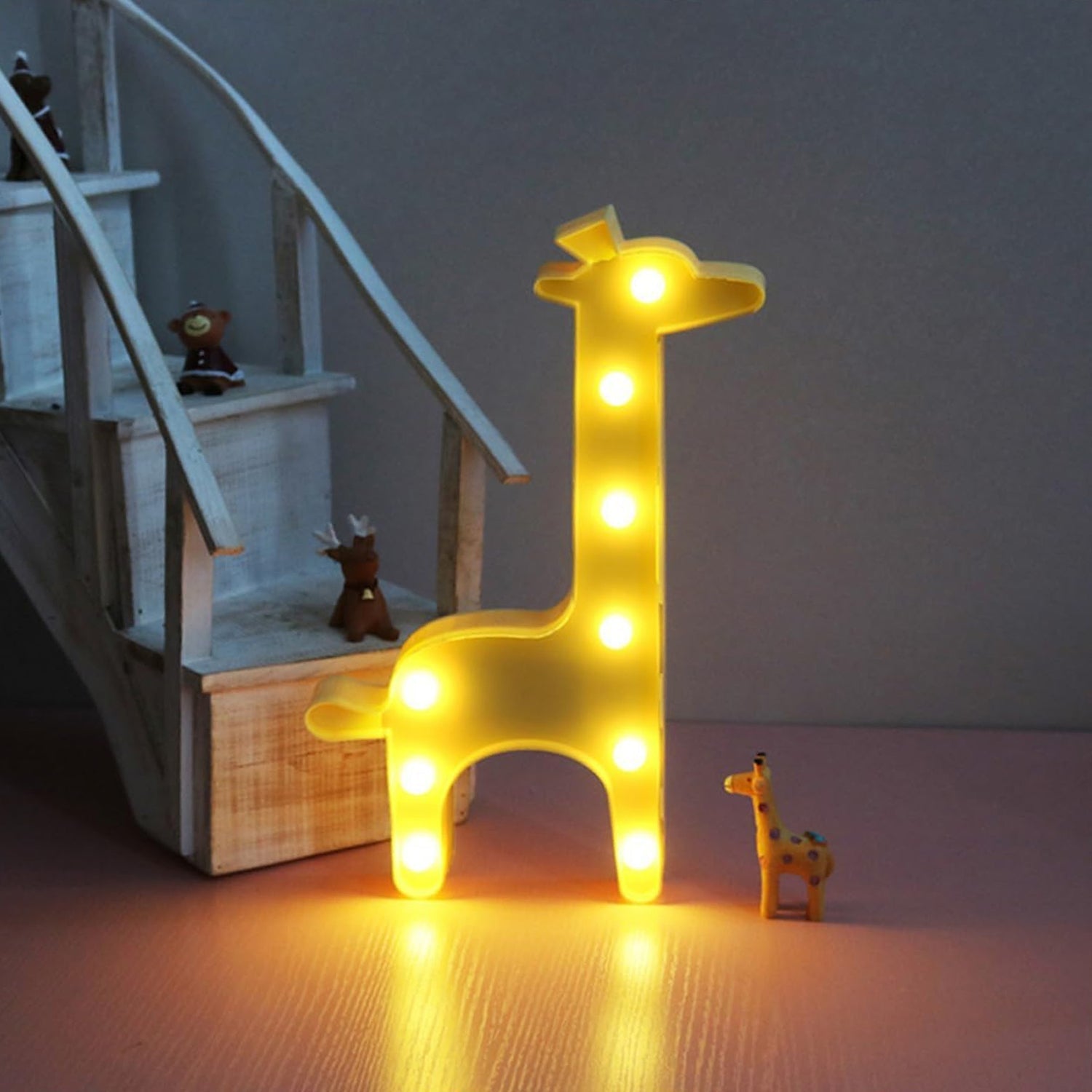 Portable giraffe LED decorative light glowing softly in children's room