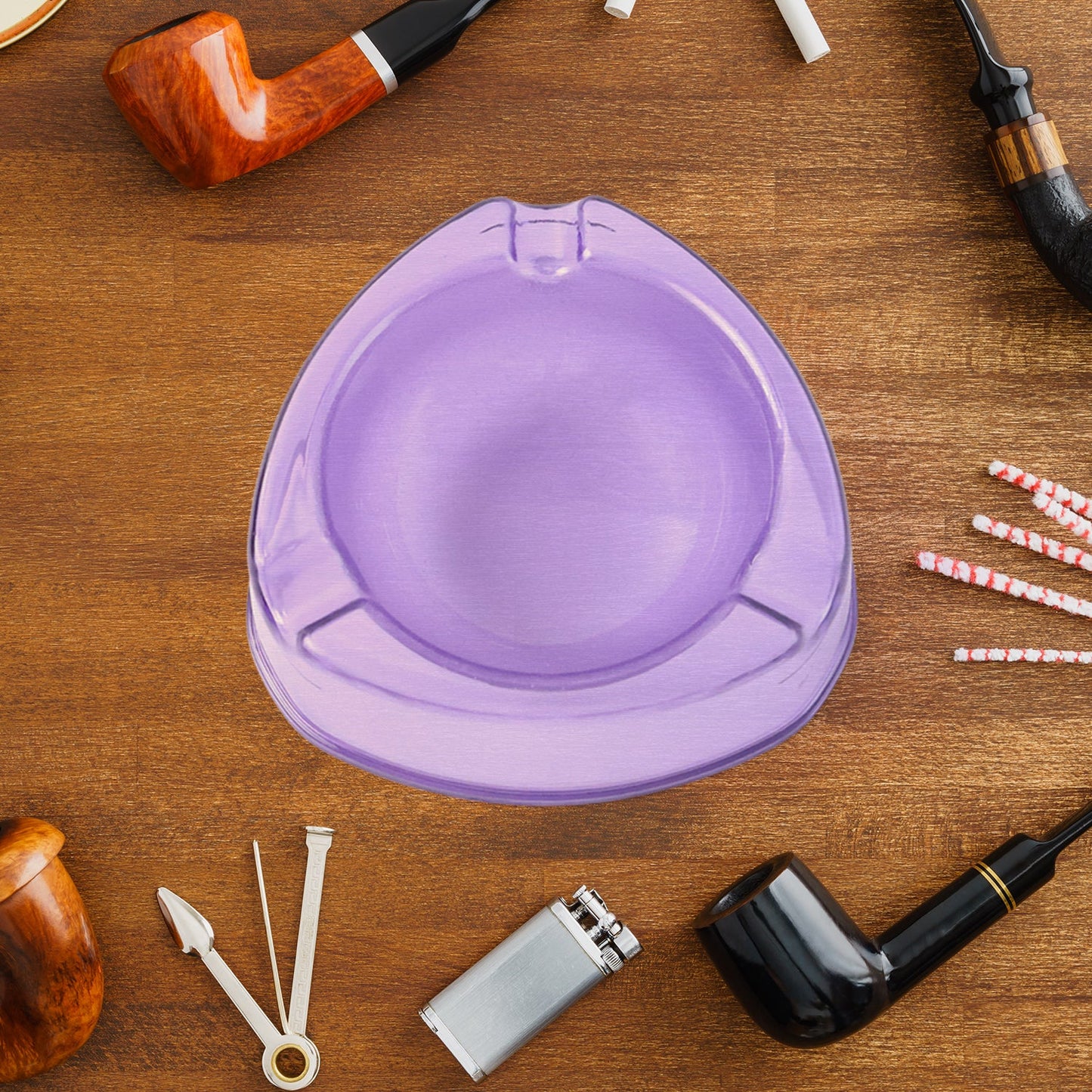 Three transparent plastic ashtrays, one gray, one blue, and one purple, are arranged on a white background.
