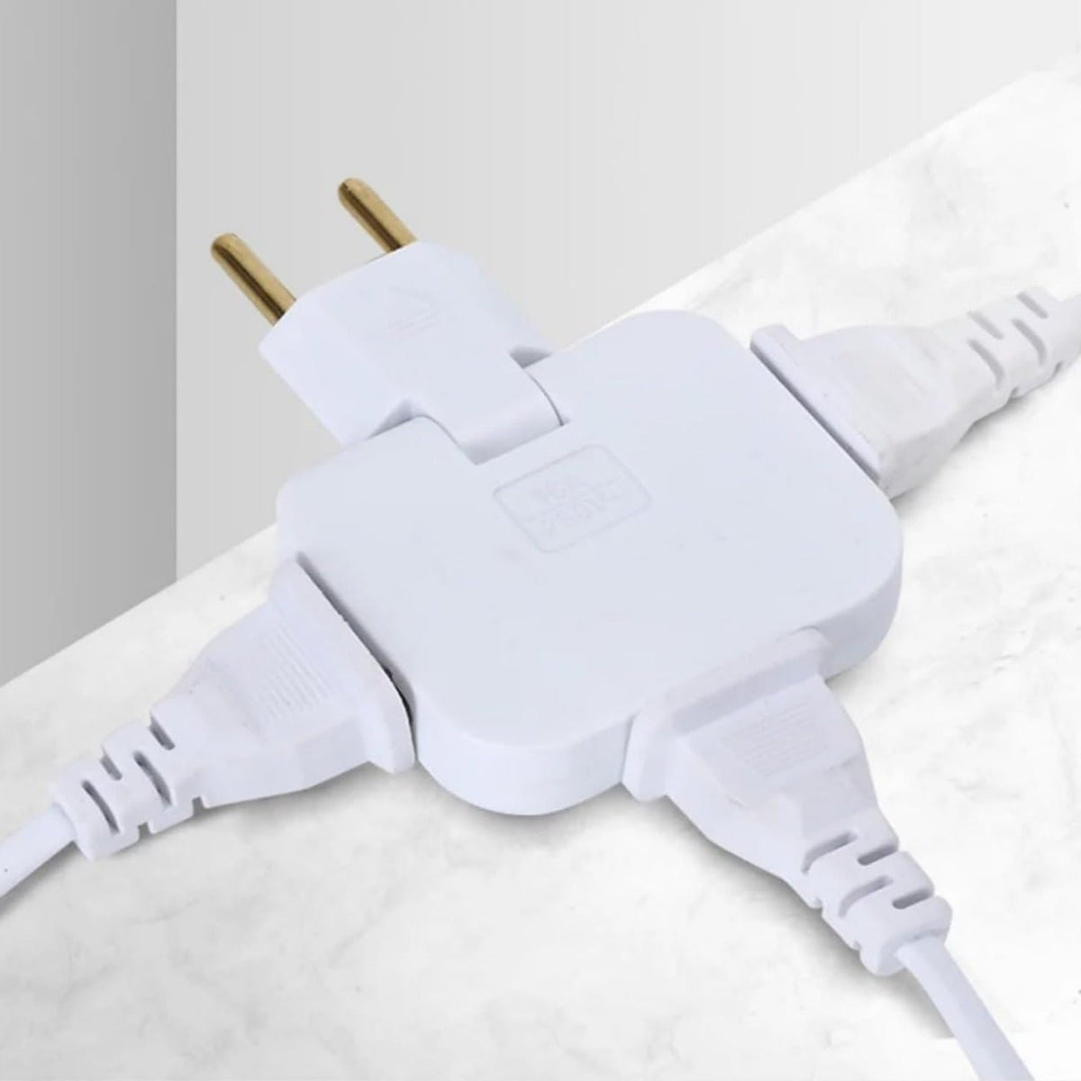 A white 3-in-1 foldable wall plug adapter with three white cords plugged in, against a light textured background.