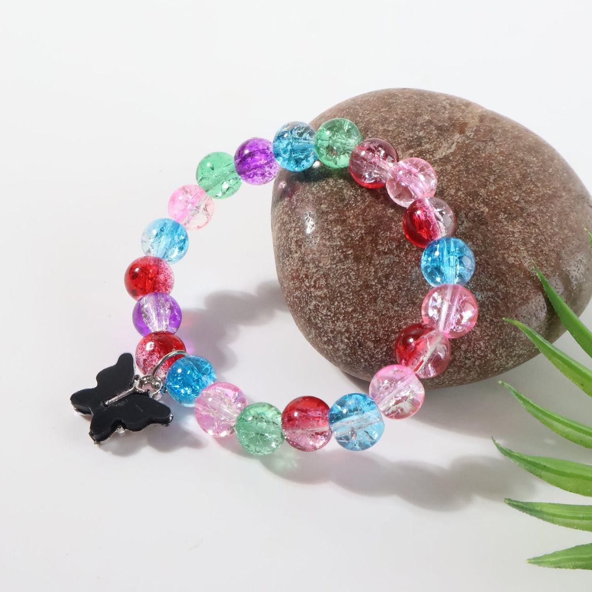Fashion bracelet with contrasting butterfly pendant charm
