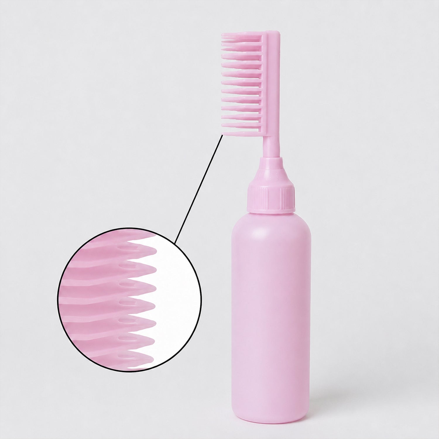 A close-up view highlights the individual teeth of the pink scalp comb on the applicator bottle.