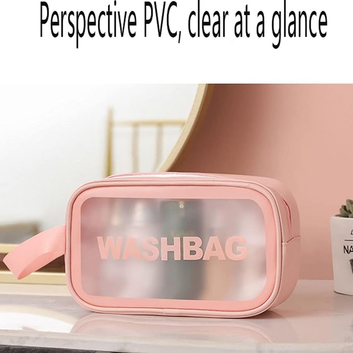 A small pink waterproof travel bag with a clear panel sits on a white marble surface next to a small plant.