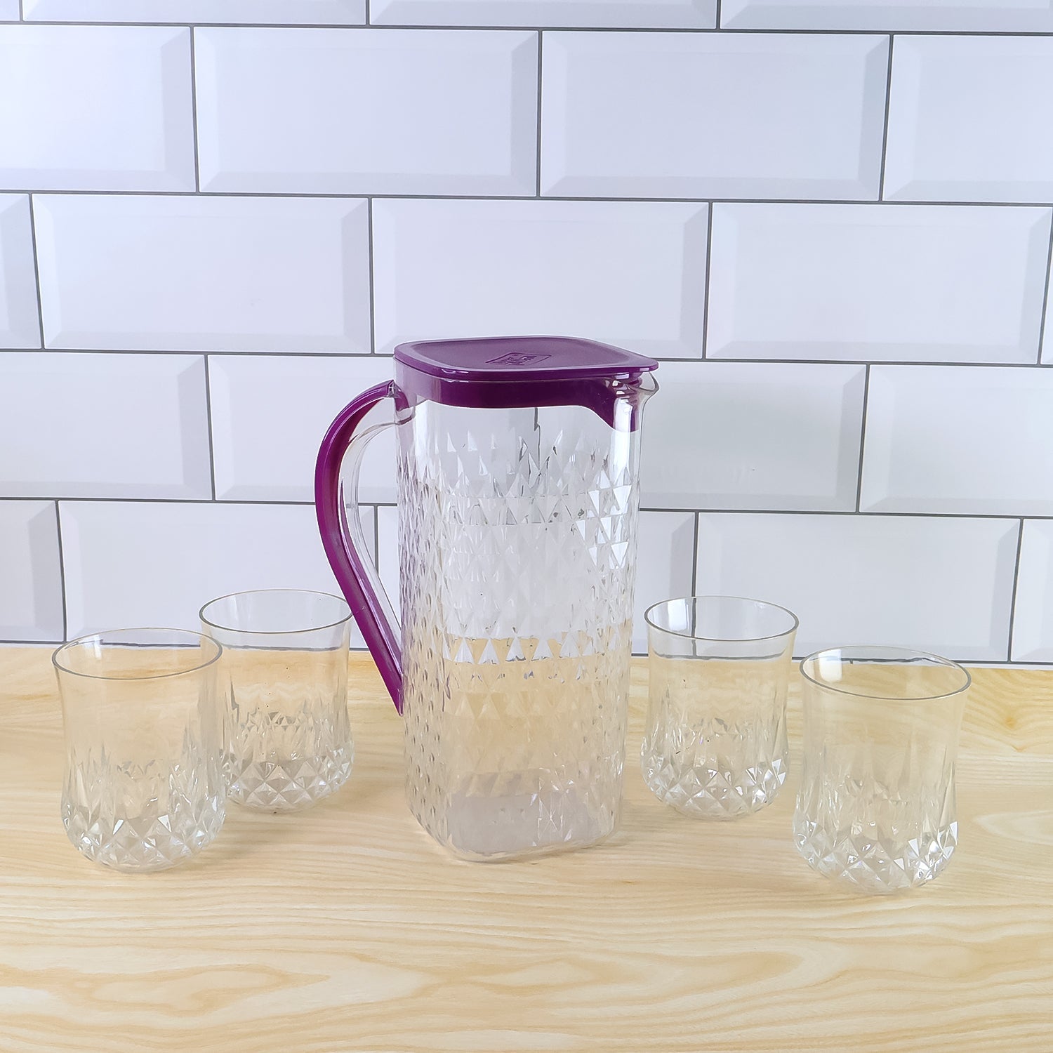Side view of BPA-free plastic jug and glasses combo set with easy pour design
