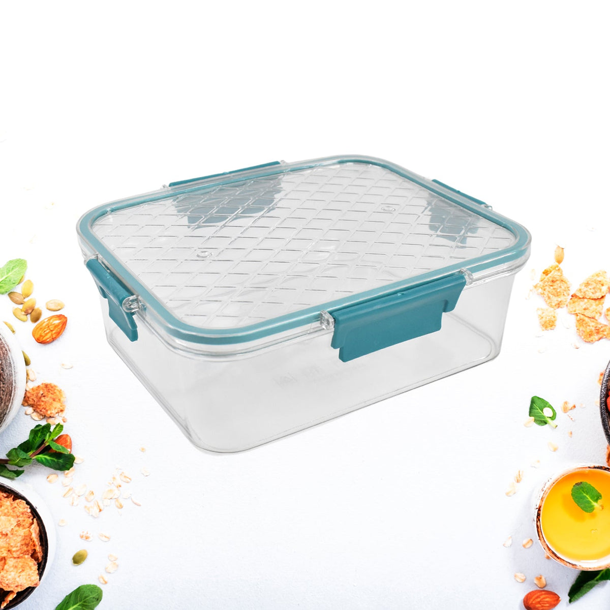 A single clear rectangular food container with a teal locking lid is surrounded by scattered breakfast ingredients.