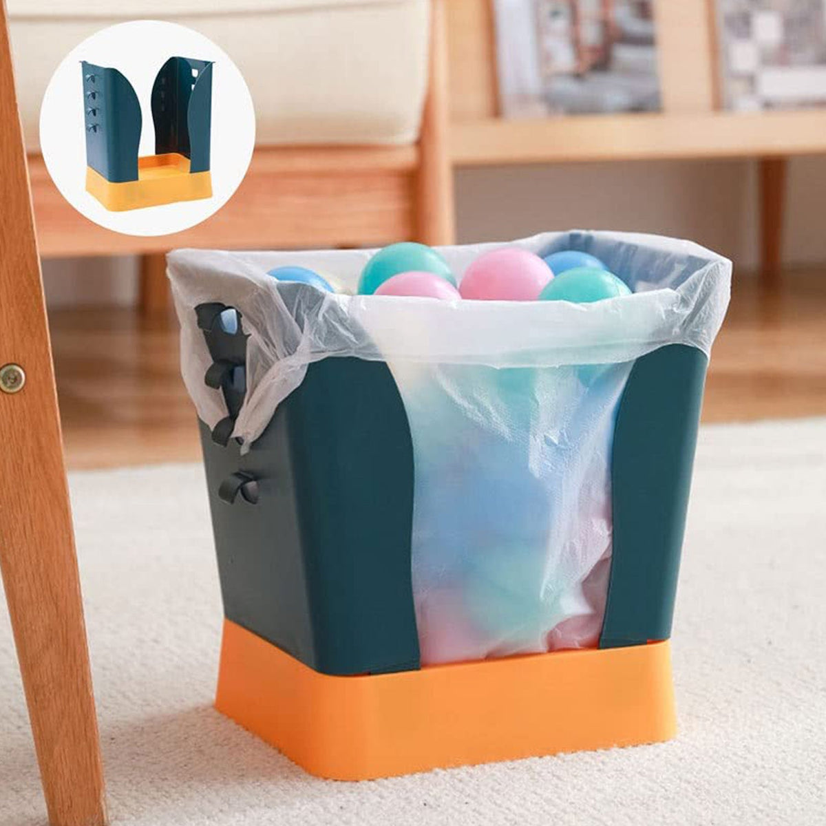 A teal and orange trash bag holder with a clear bag full of colorful balls sits on a rug.