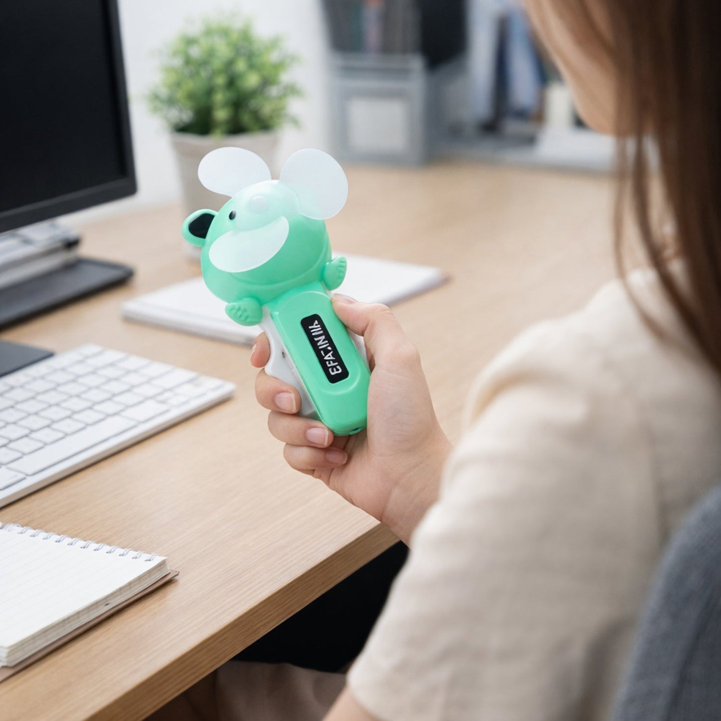 Smooth rotating blades of mini handheld fan for quiet airflow
