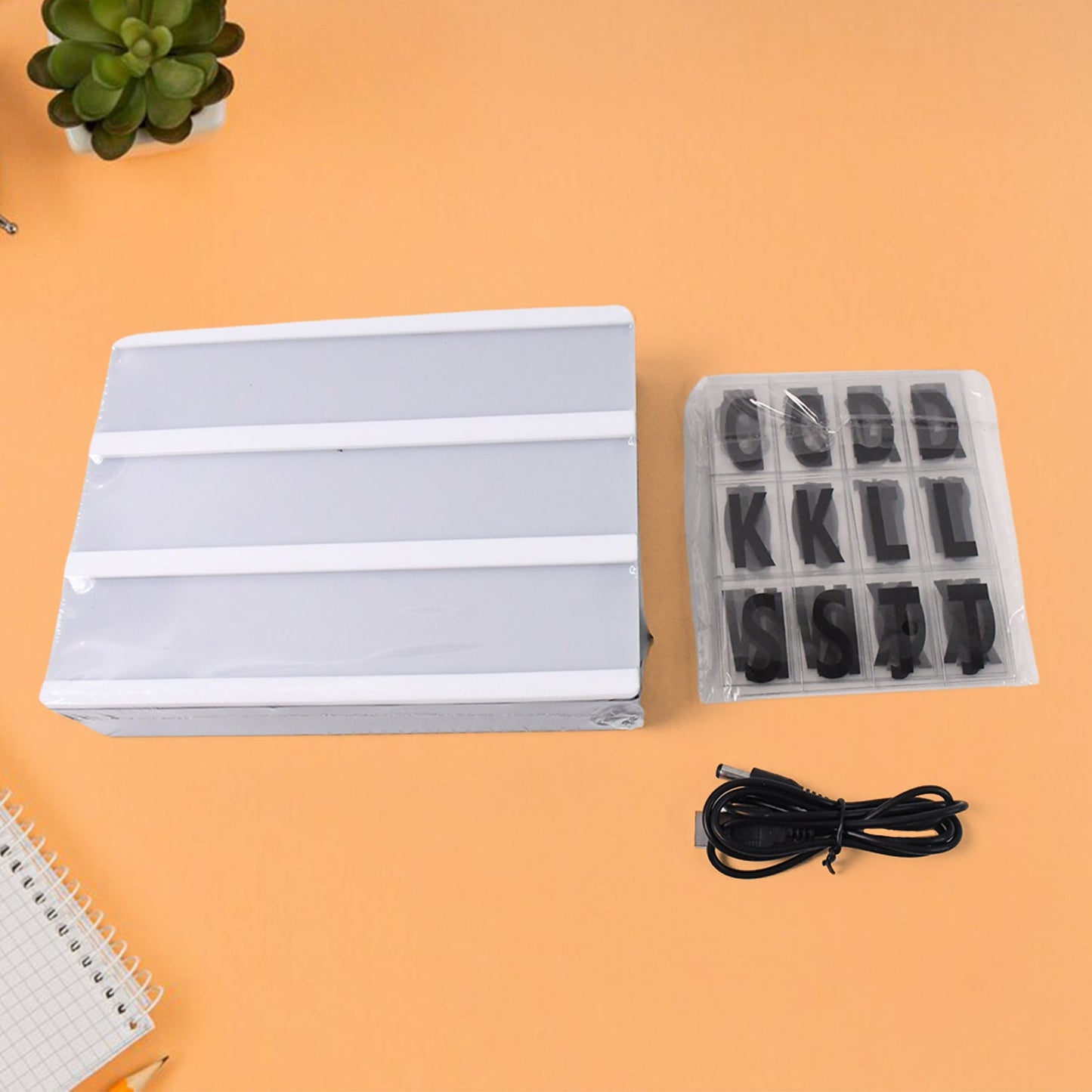 Decorative LED message board adding a warm glow to a modern living room shelf.