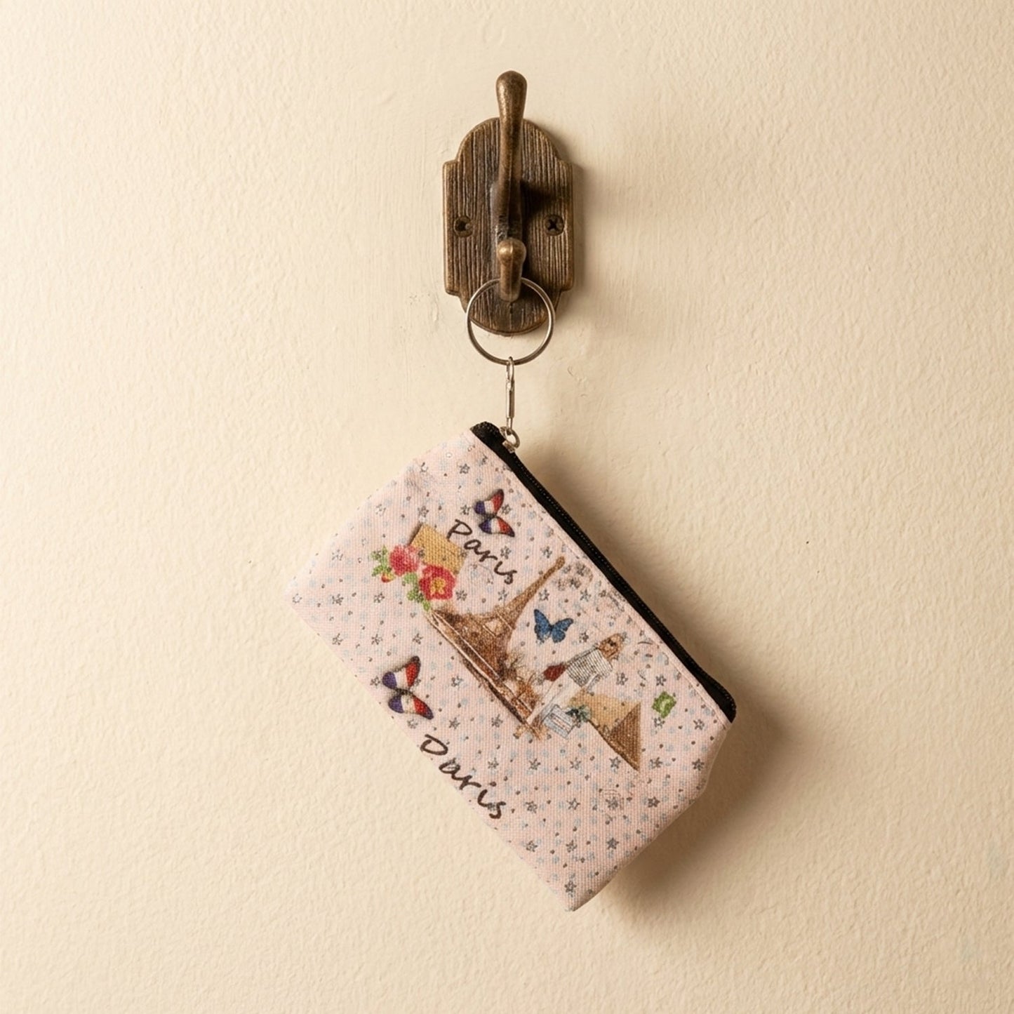 Compact coin pouch with a secure zip closure and Paris print