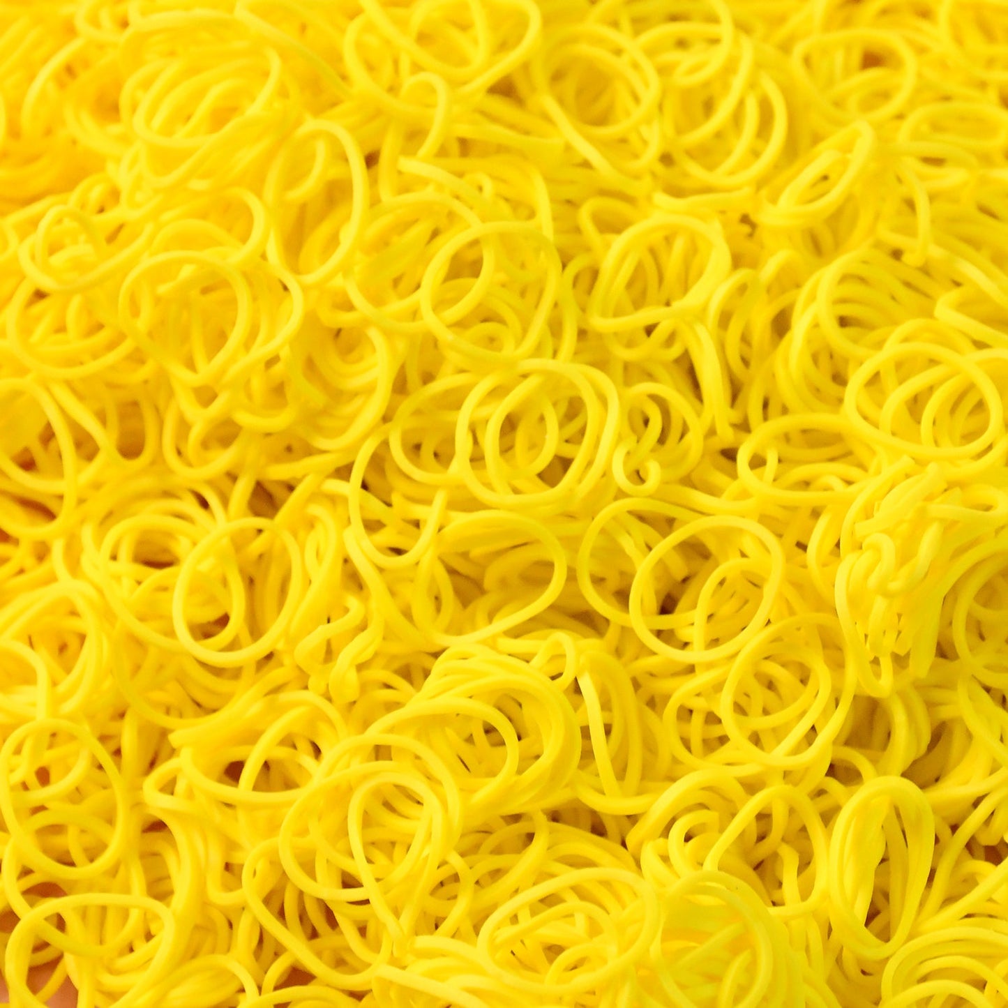 Close-up of durable elastic rubber bands in bright orange