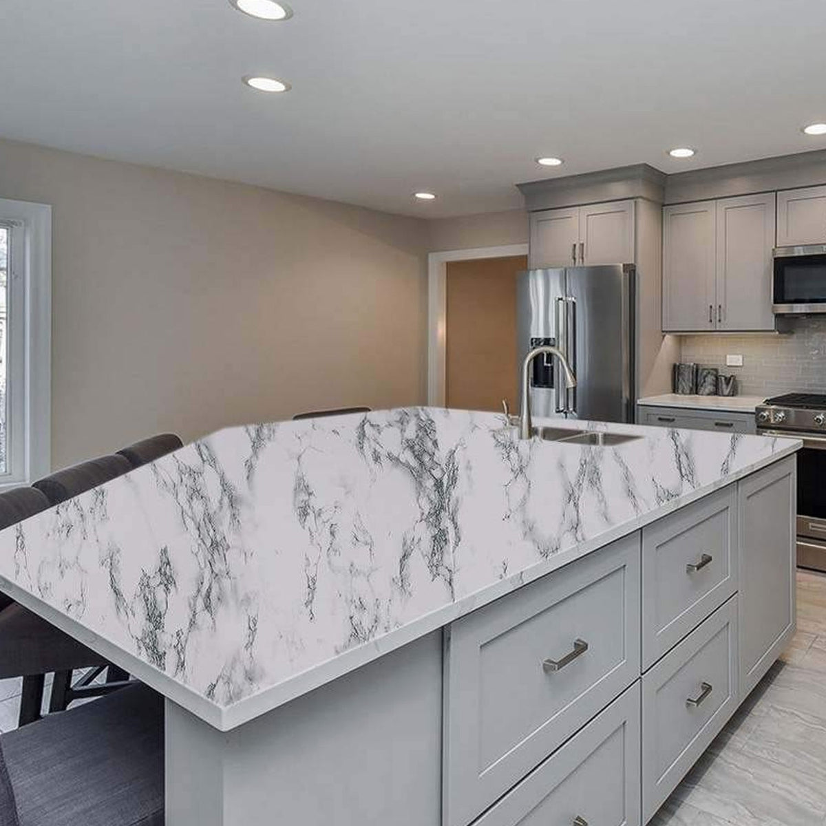 A kitchen island countertop covered with white and grey marble pattern self-adhesive wallpaper.