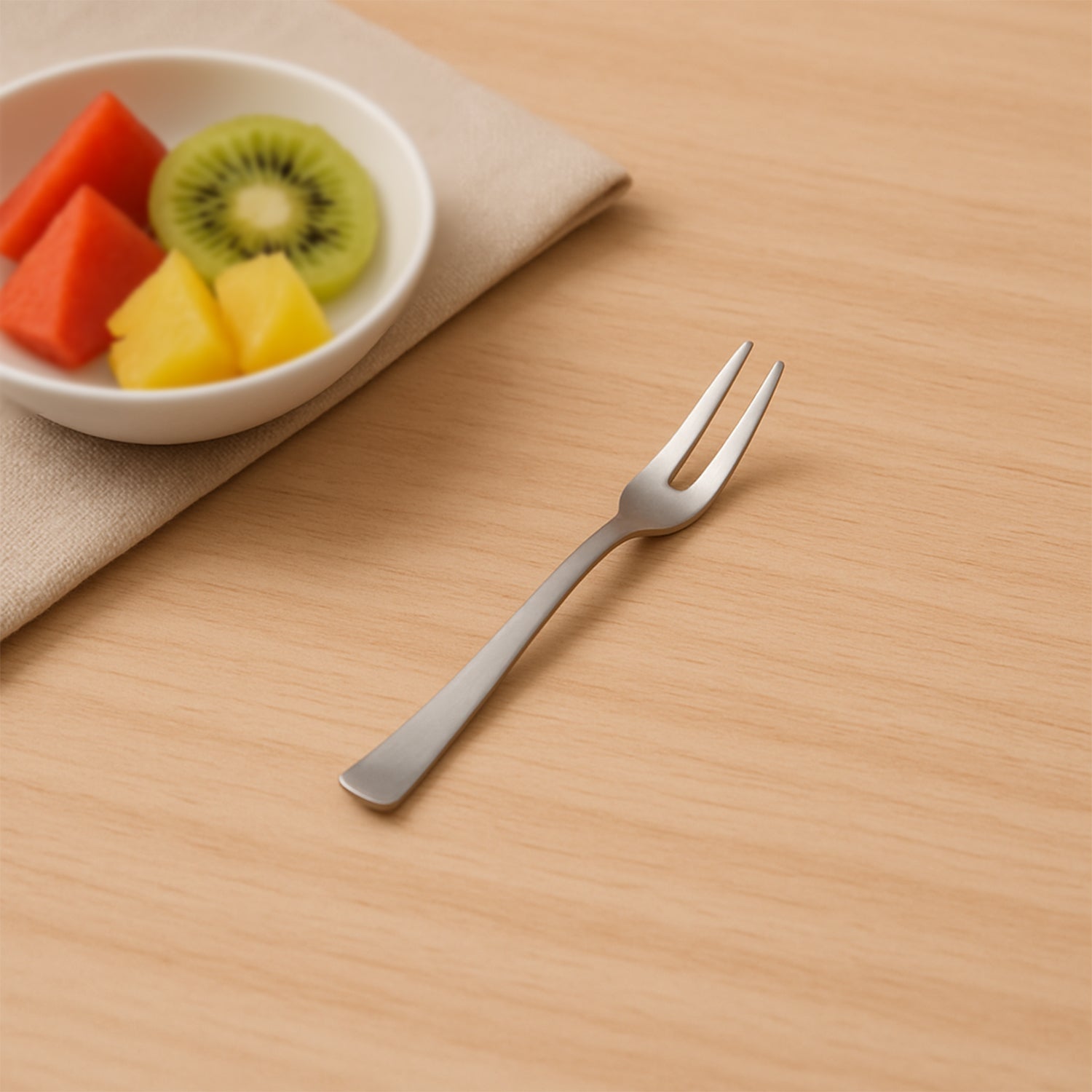 Stainless steel fruit forks neatly arranged on dining table