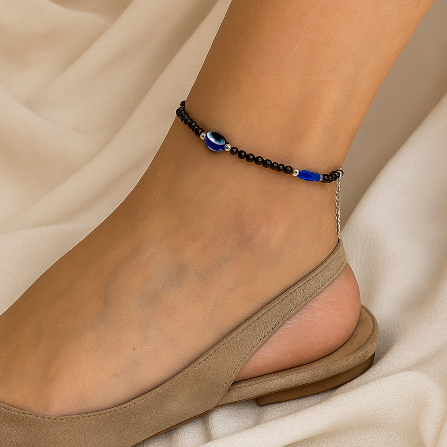 Evil eye charm bracelets featuring black and blue beads close-up