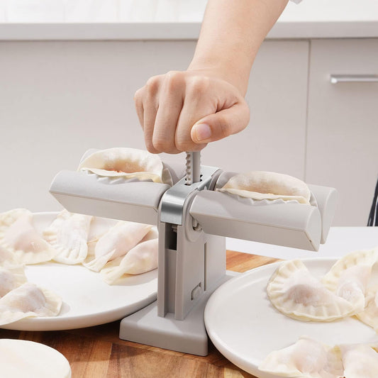 Double head dumpling maker mold in use, creating two perfectly shaped dumplings.