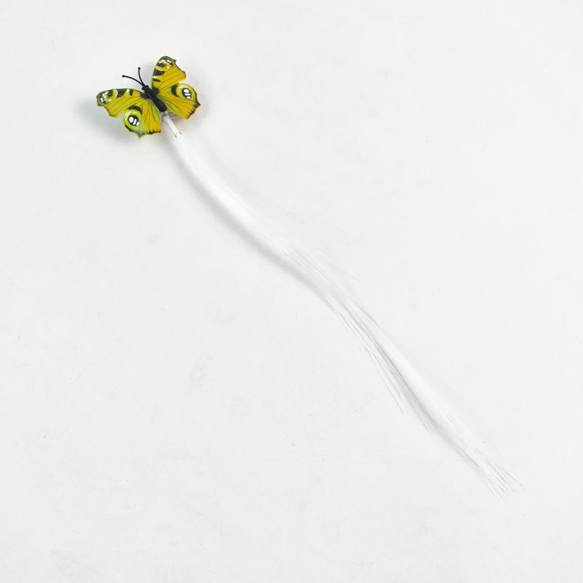 A single yellow butterfly hair clip with long white fiber optic strands is displayed on a plain white background.