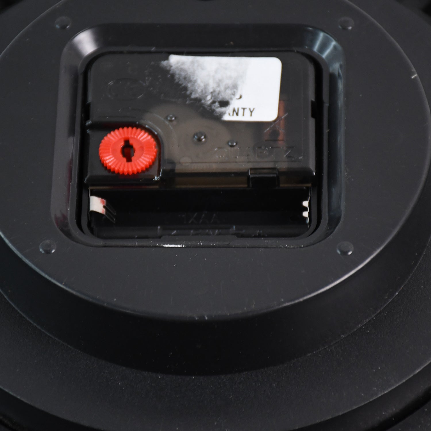 Side view of silent sweep plastic wall clock with easy mount hook