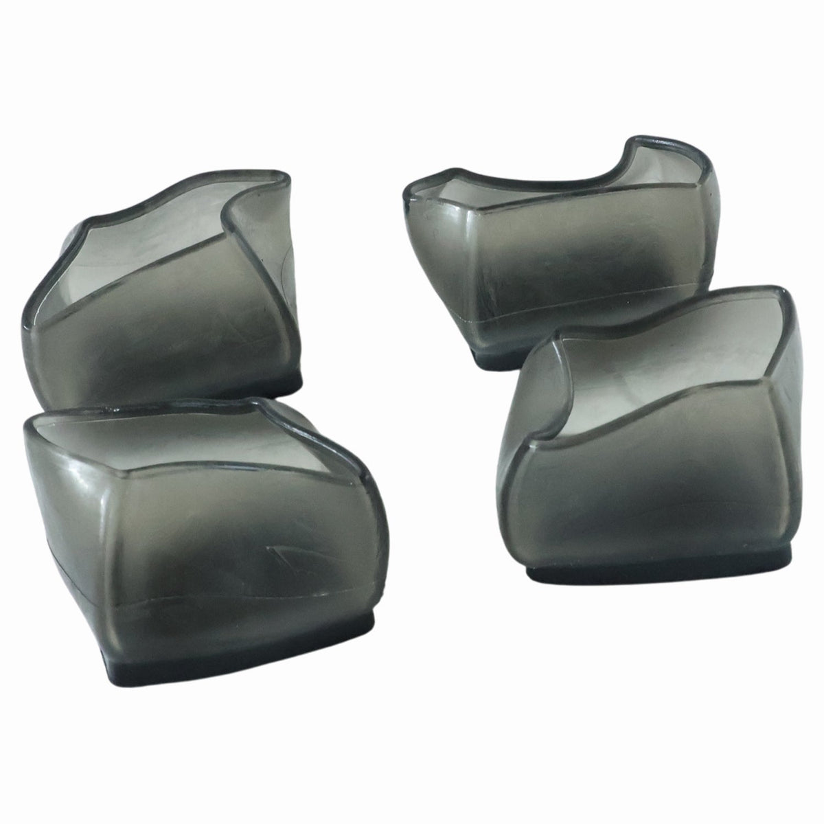 Four dark grey silicone furniture leg caps are arranged on a white background.