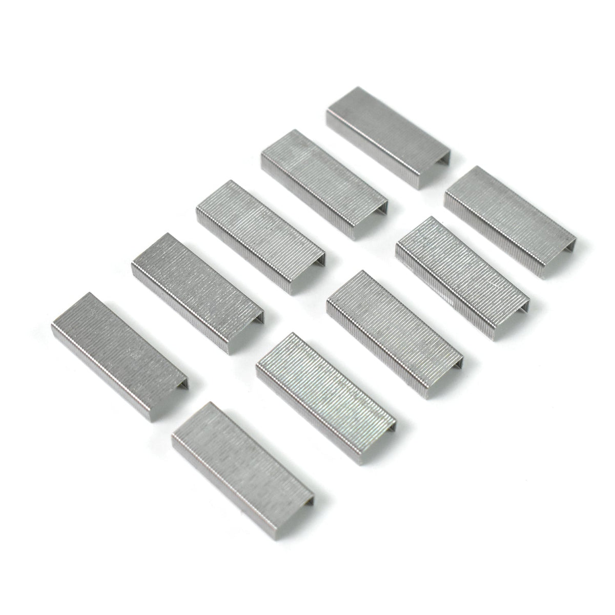 Ten silver staple strips arranged in two rows on a white background, ready for a mini stapler.