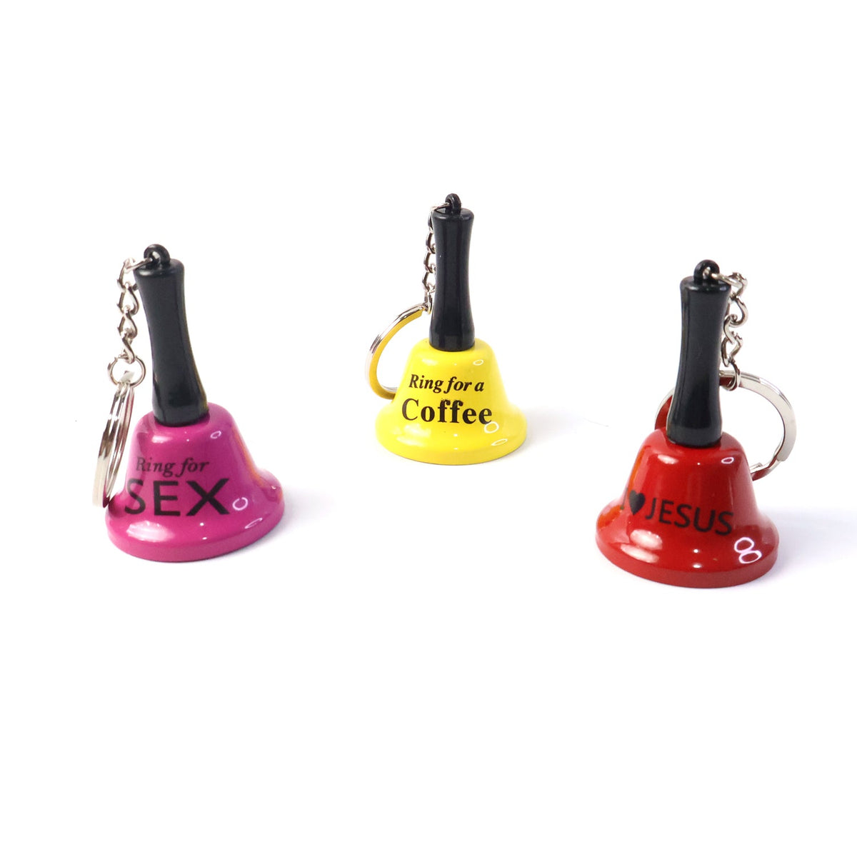 Three mini hand bell keychains, one pink, one yellow, and one red, each with a different phrase, against a white background.