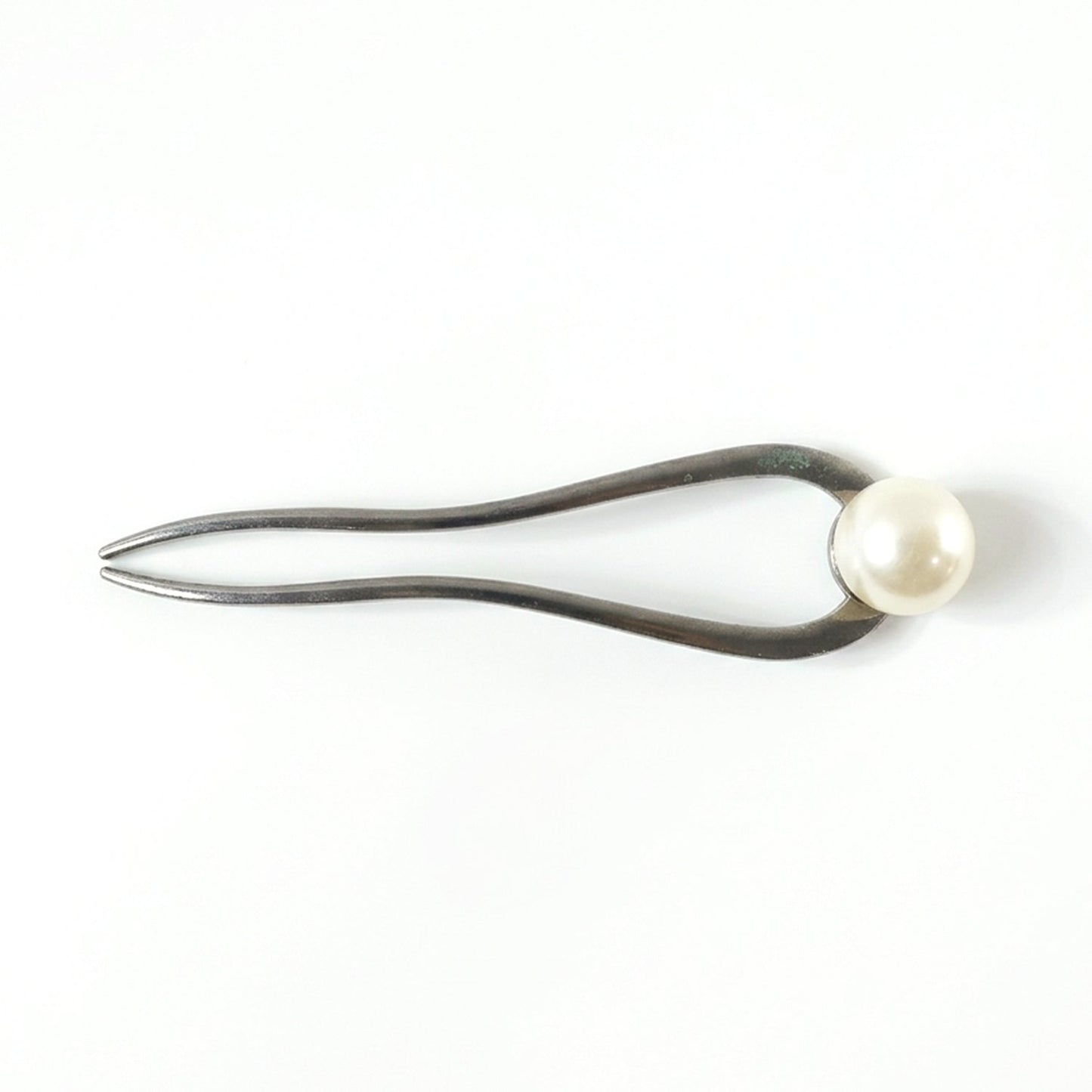 Close-up of pearl hair pin detail