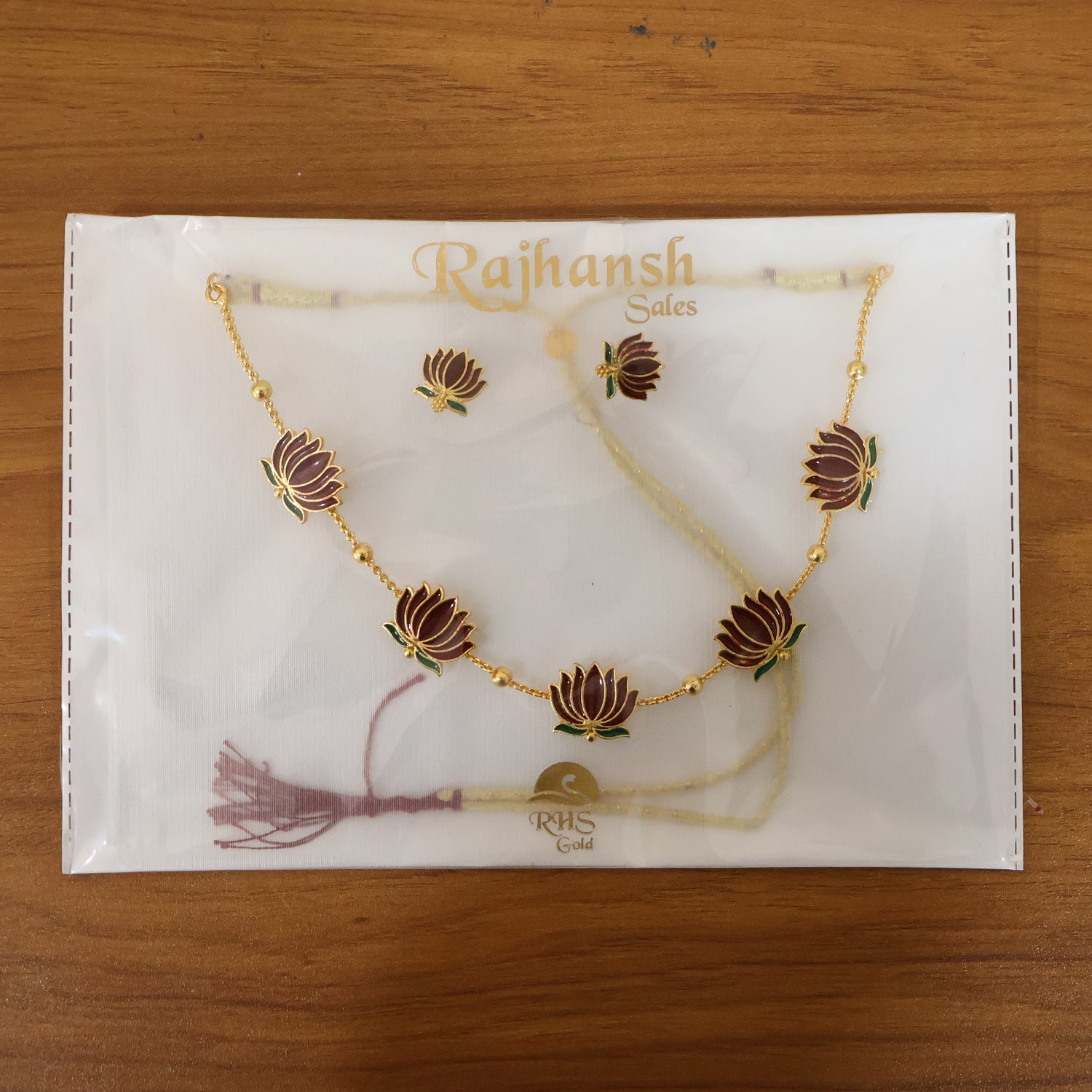 Stud earrings matching lotus design necklace in ethnic jewellery collection