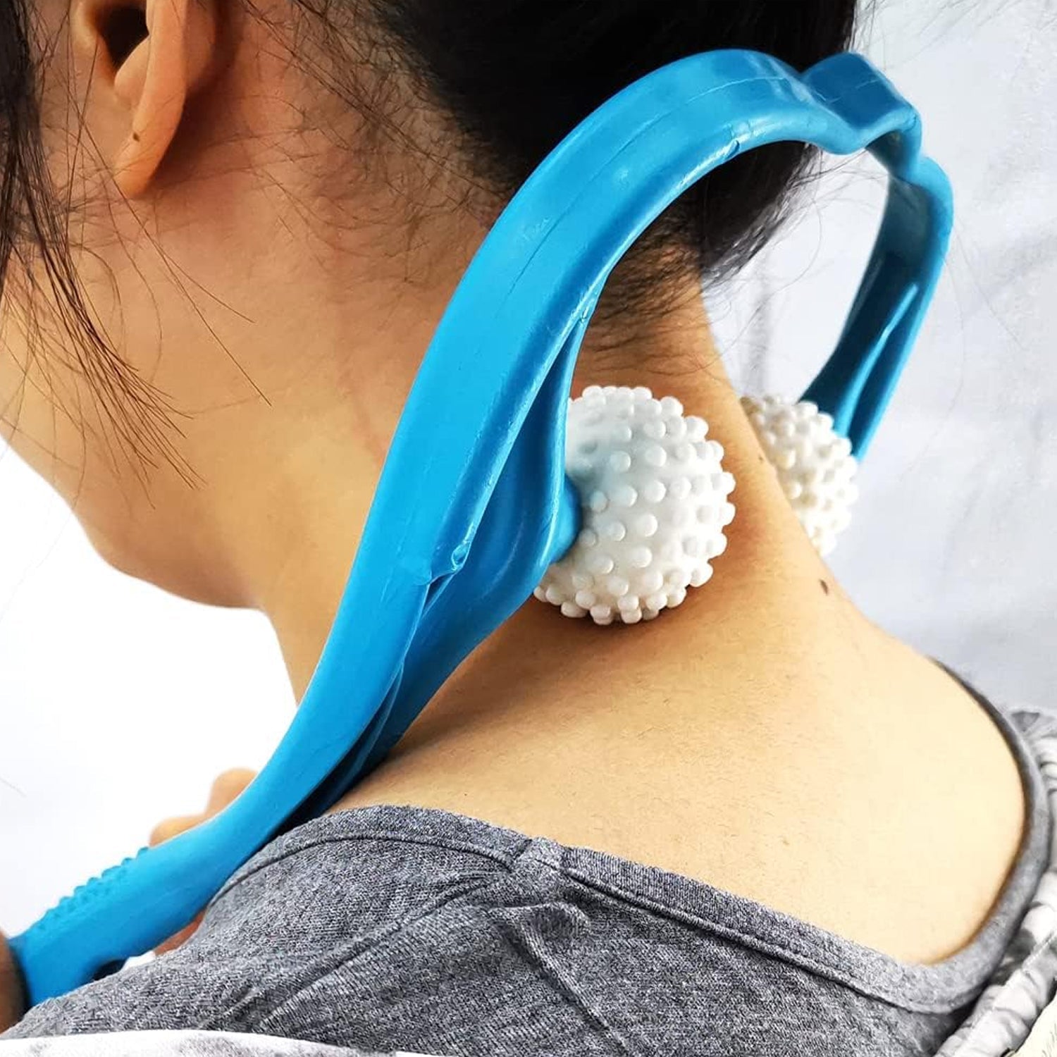 Woman experiencing deep relaxation with the Blue U-shaped neck and shoulder massager at home.