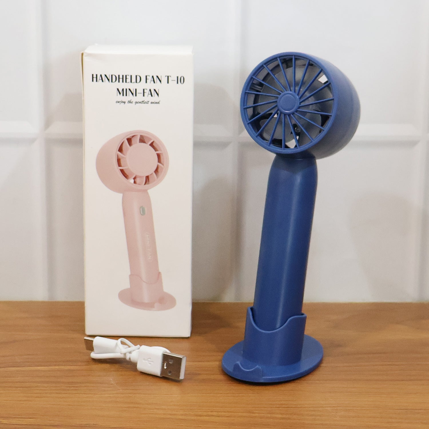 Comparison shot of  rechargeable mini handheld fan size and design
