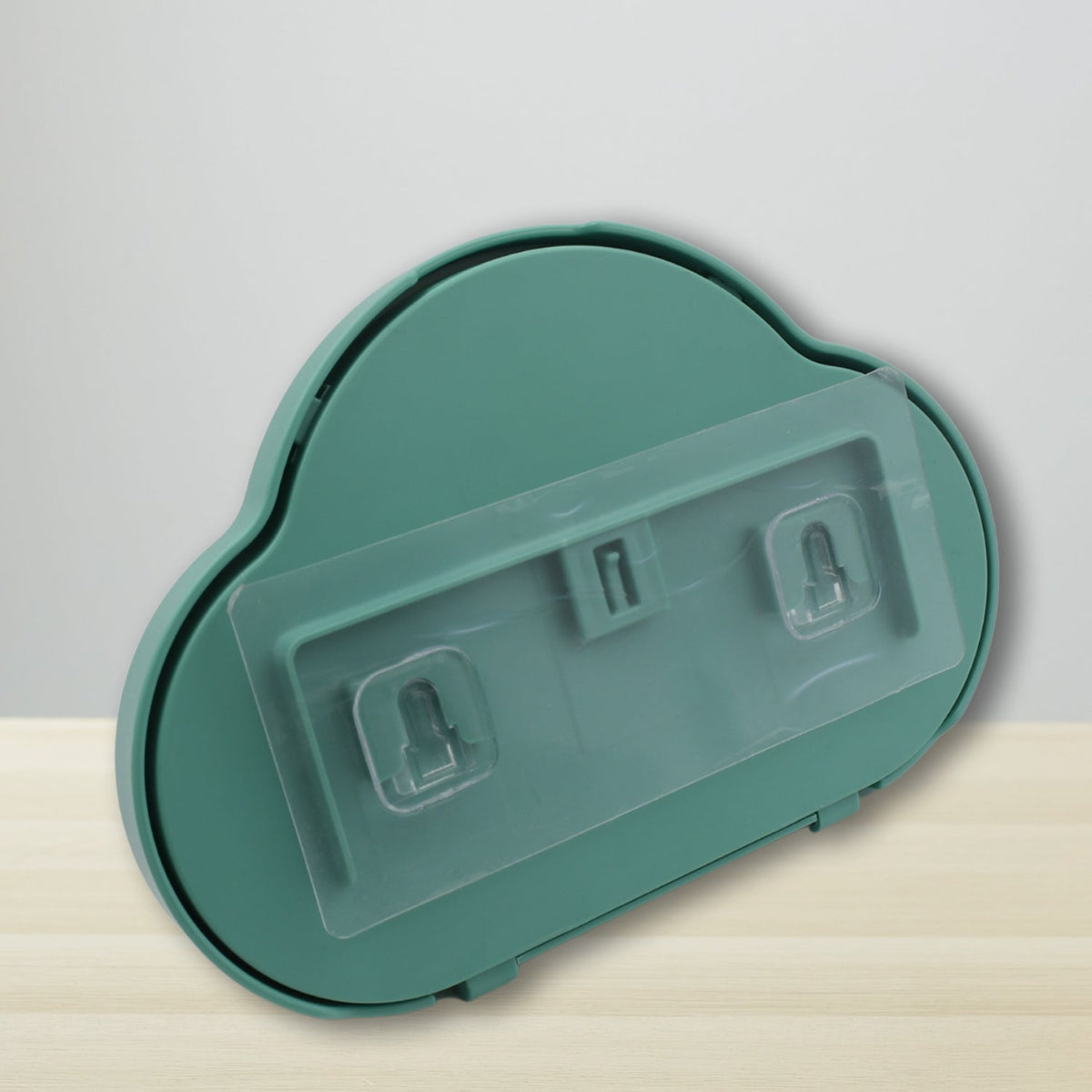 The back of a teal cloud-shaped phone holder showing clear adhesive strips and hooks.