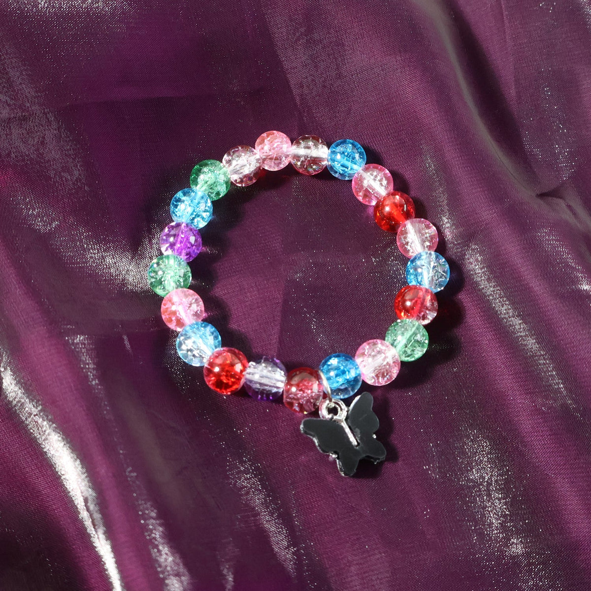 Black butterfly charm on multicolor crackle-bead bracelet