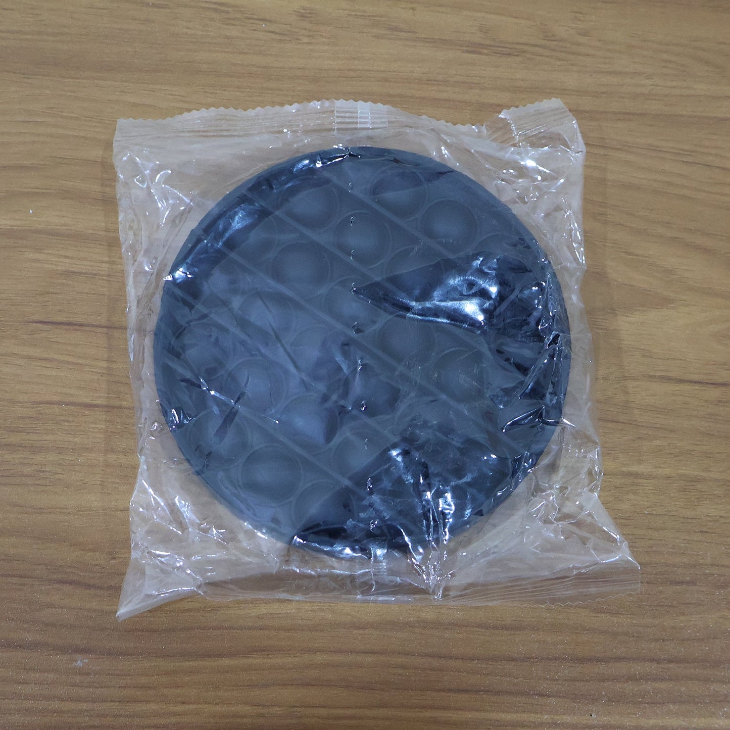 Back view of round silicone Pop It fidget toy for sensory play