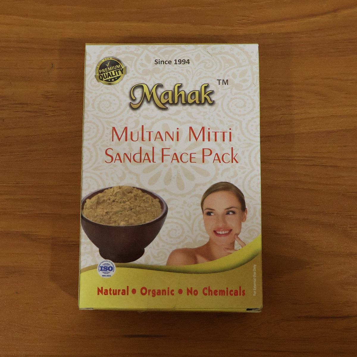 Top-down view of the Mahak Multani Mitti Sandal Face Pack box on a wooden surface.