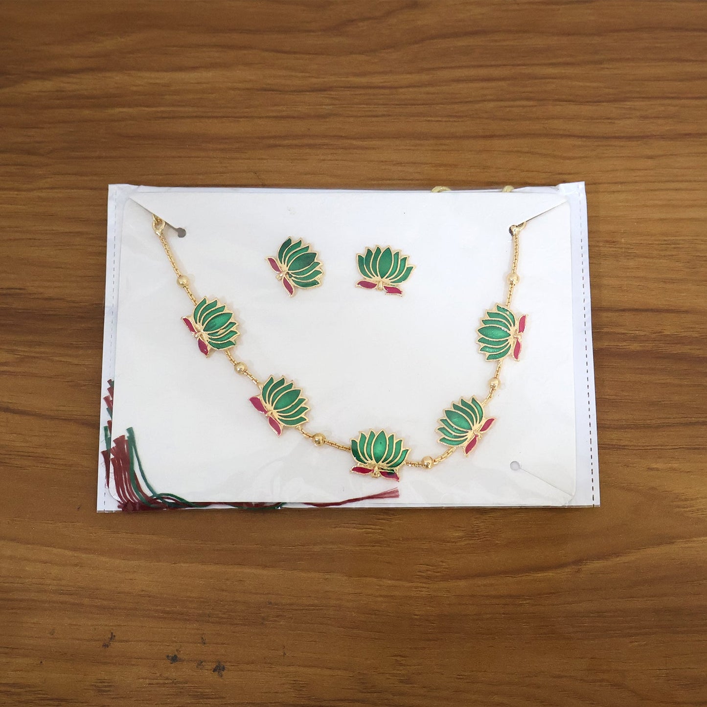 Elegant ethnic jewellery set with green lotus motifs and gold finish