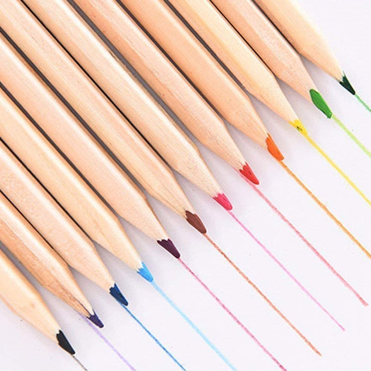 A close-up of the tips of 12 wooden colored pencils, each drawing a thin, colorful line on a white surface.