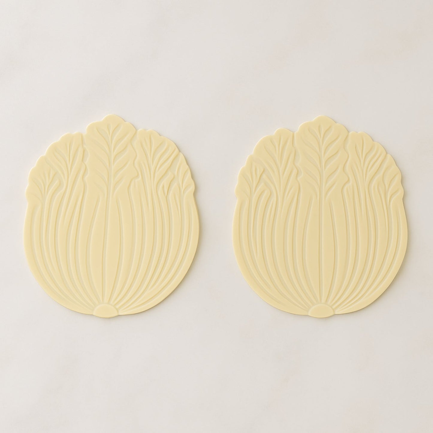 Silicone leaf coaster protecting surface from heat and moisture with hot beverage