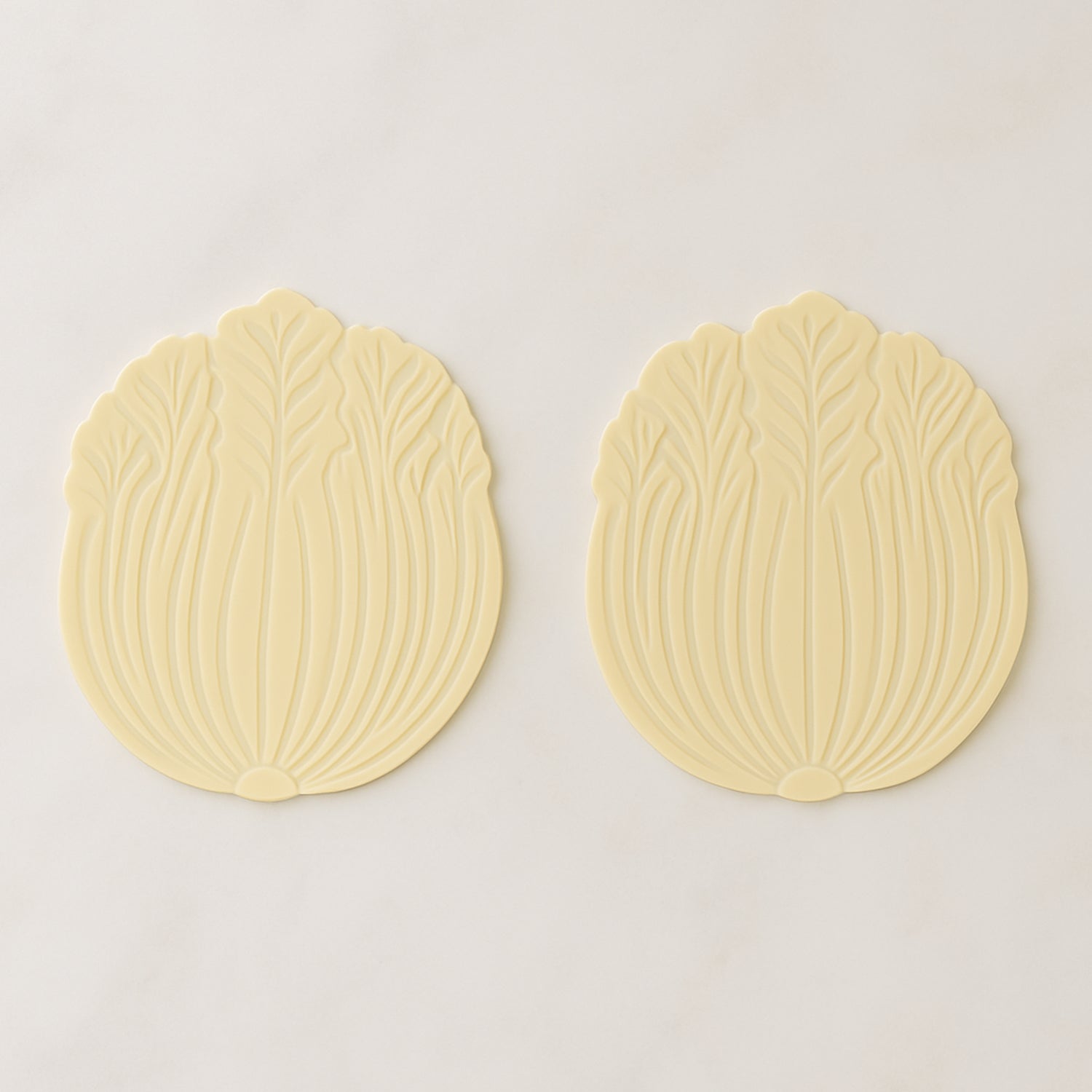 Silicone leaf coaster protecting surface from heat and moisture with hot beverage