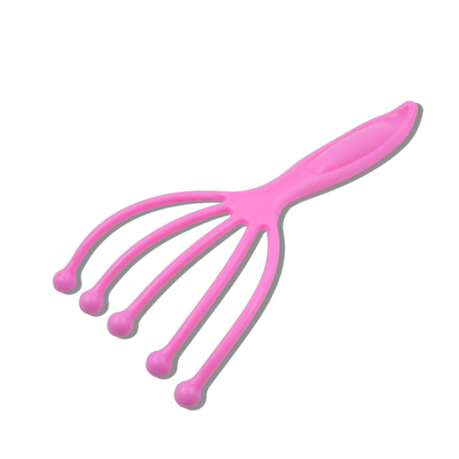 A bright pink plastic scalp massager with five flexible arms, each ending in a rounded pink tip, casting a shadow on a white