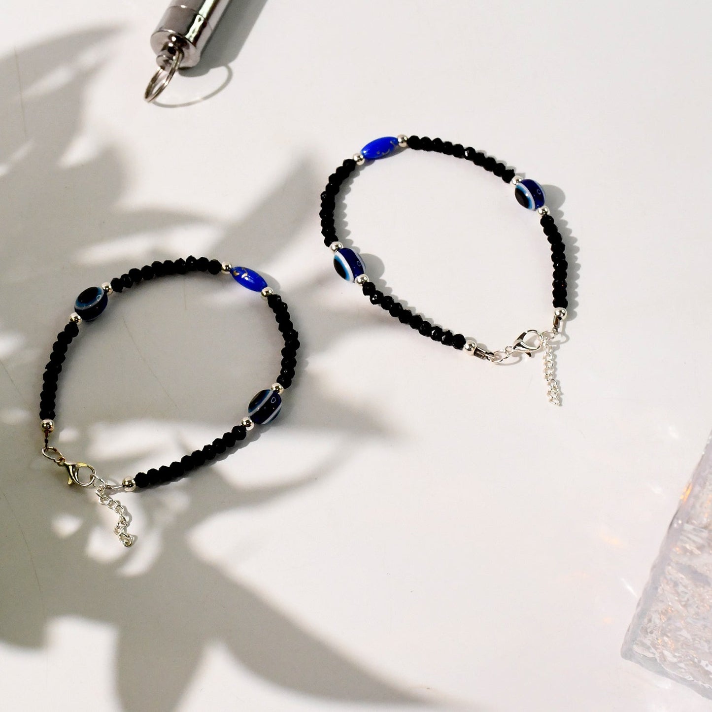 Unisex adjustable black evil eye bracelet set with silver accents