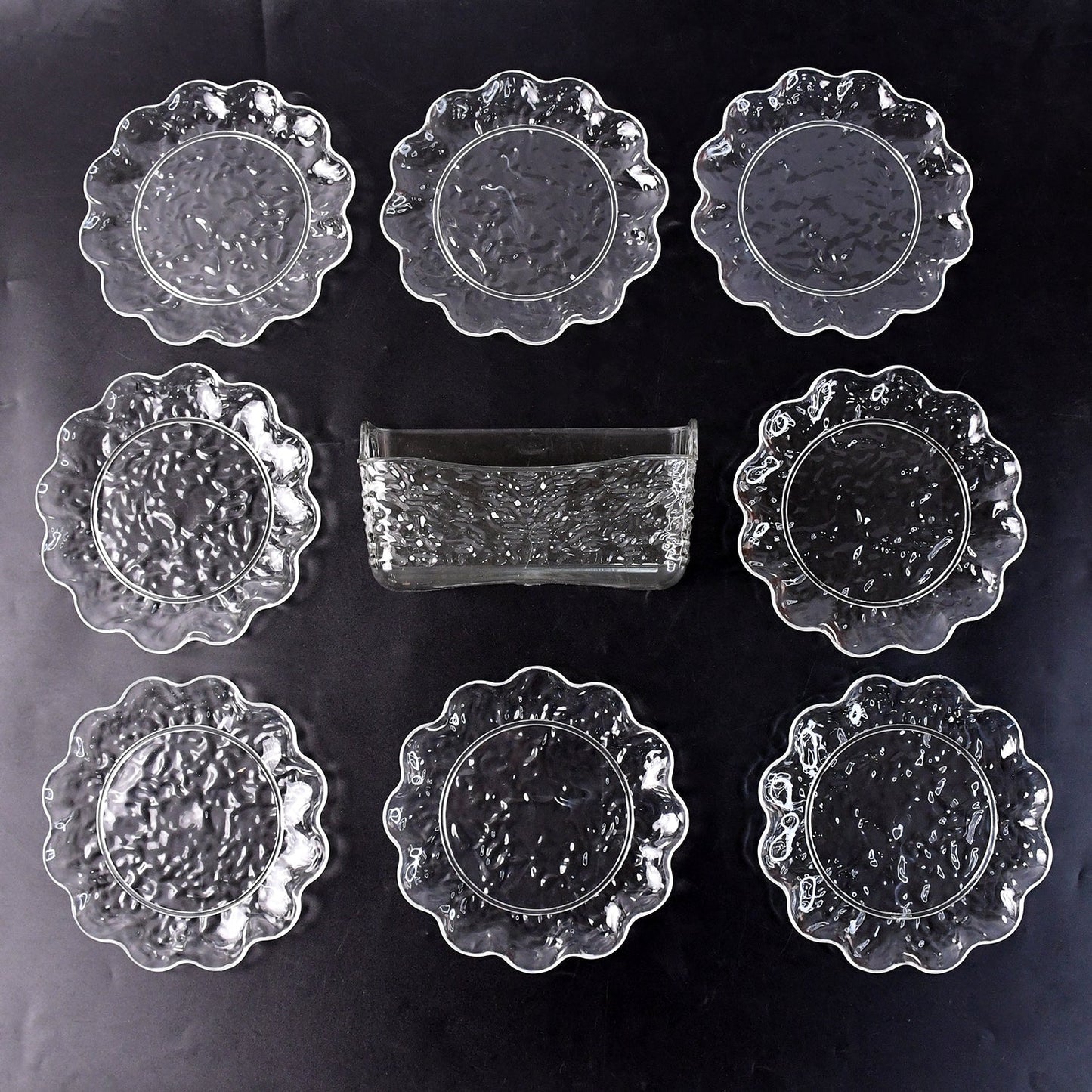9-piece plastic bowl set with serving tray displaying transparent bowls and plates