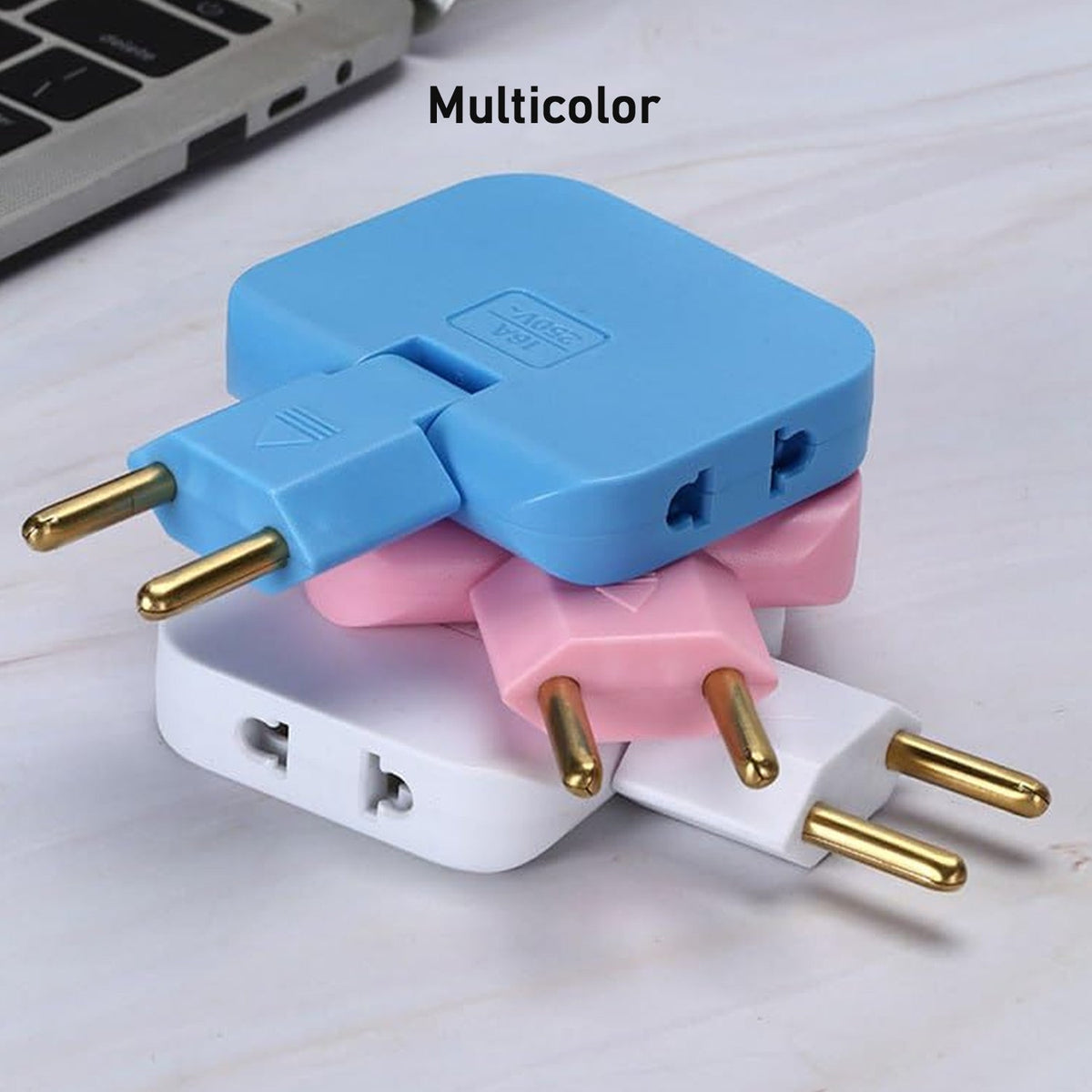 A stack of three 3-in-1 foldable wall plug adapters in blue, pink, and white, on a light marble surface.