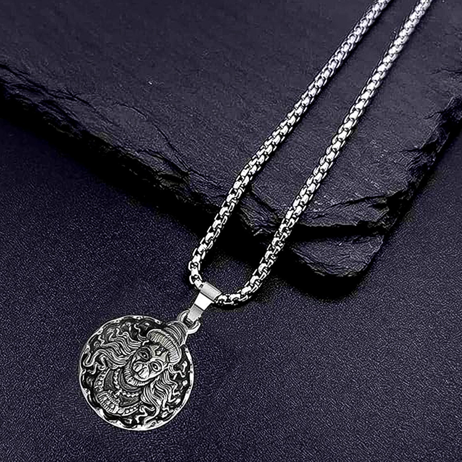 Close-up of the handcrafted Hanuman Locket with silver chain, showcasing intricate details.