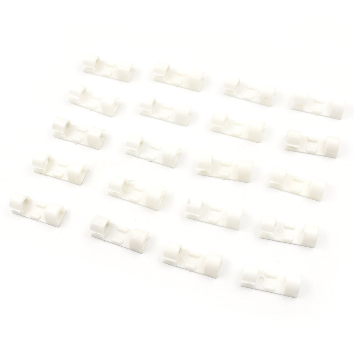 Twenty white plastic cable clips arranged in four rows of five on a clean white background.