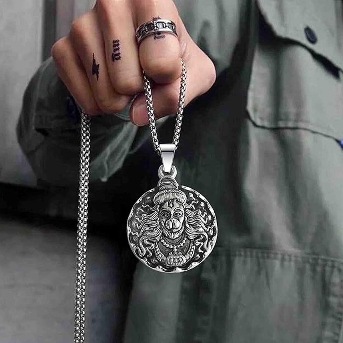 Detailed view of the Bajrangbali pendant's design and texture.