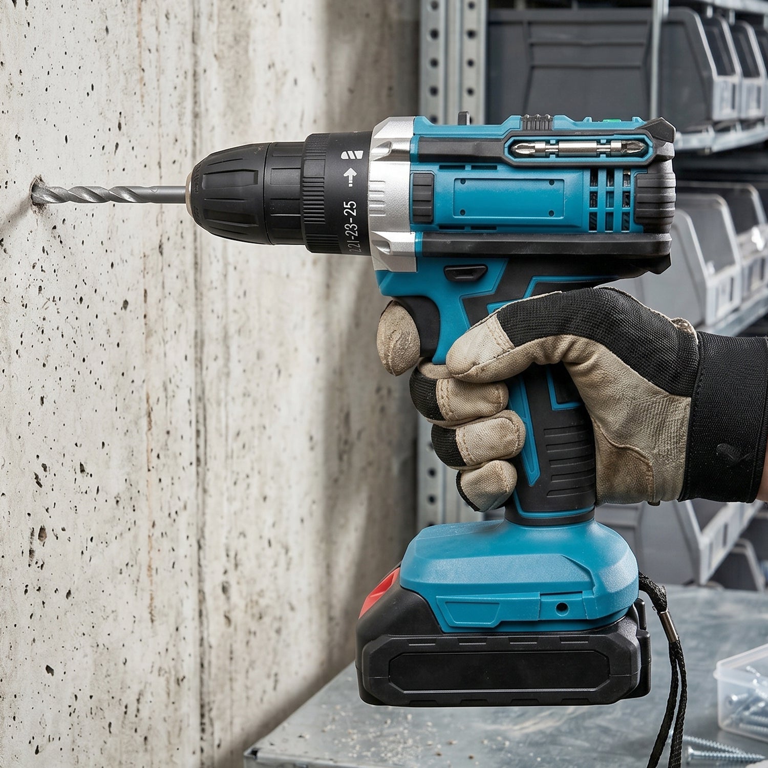 A gloved hand holds a blue and black cordless drill, actively drilling a hole into a light gray concrete wall.