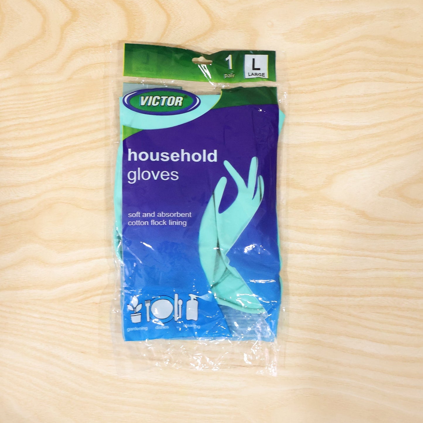 A single pair of large teal household gloves in clear plastic packaging with blue and green branding is centered on a light