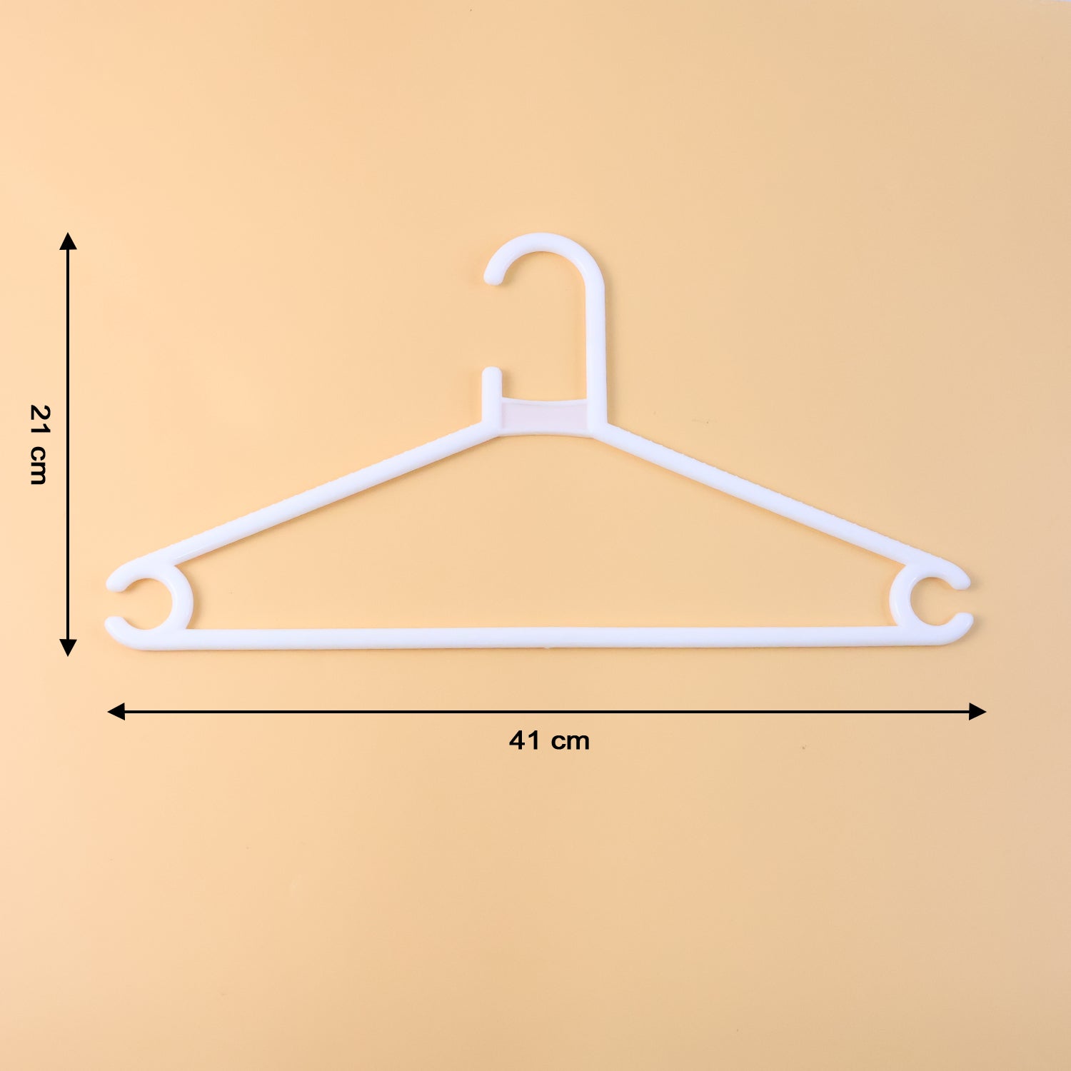 White plastic clothes hanger supporting a hanging garment